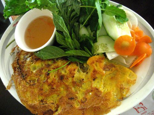 banh xeo - it's an eggy crepe filled with shrimp and pork that's served with pickled veggies and herbs to be wrapped in lettuce